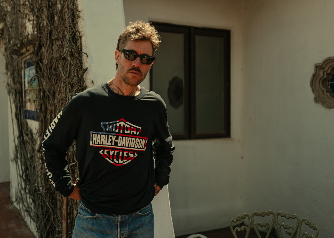 A person wearing a long sleeve HD shirt standing outdoors