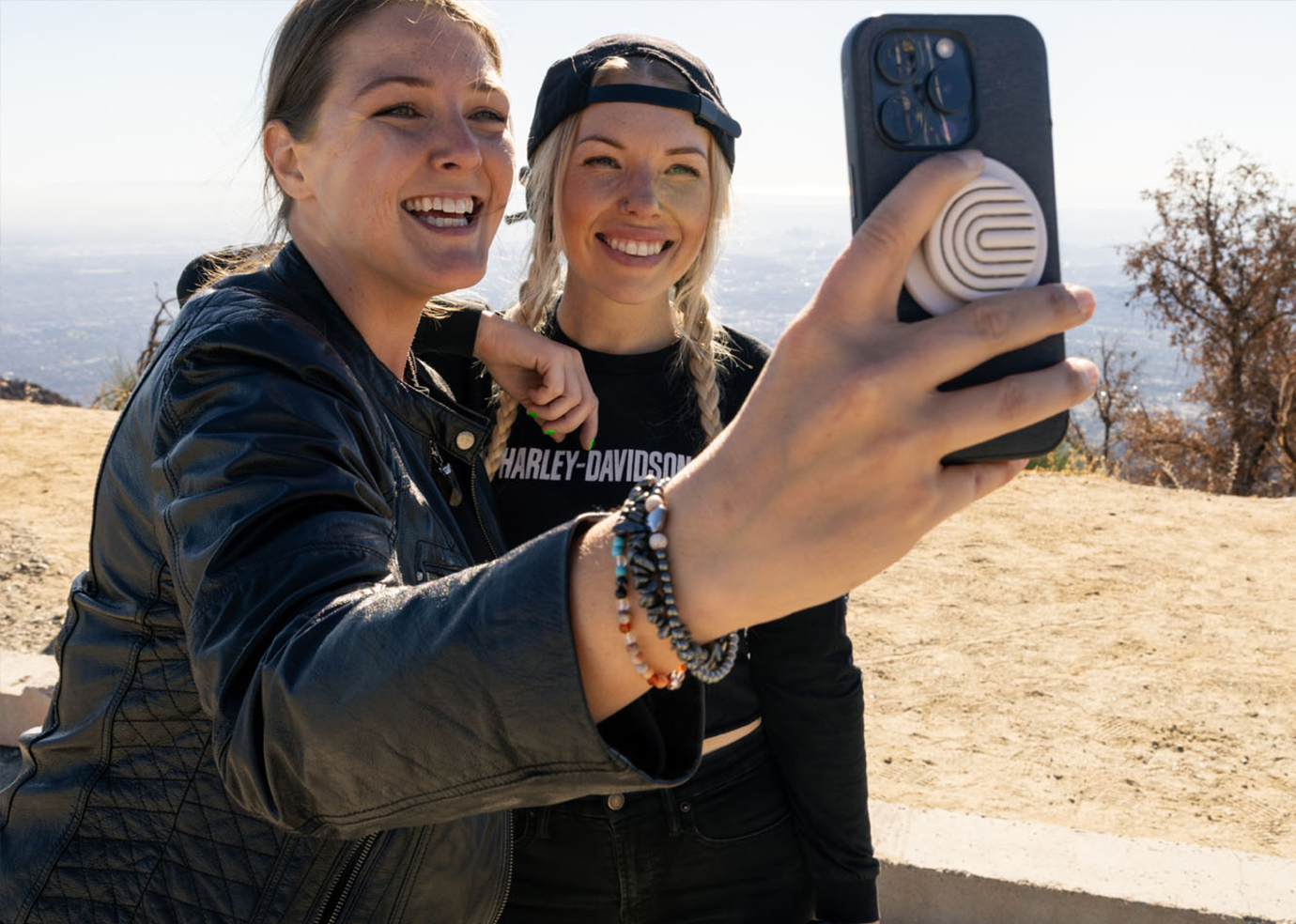 two-riders-taking-selfie-at-roadside-coastal-overlook-ls